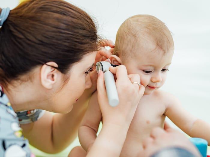 pediatrician checking baby ear